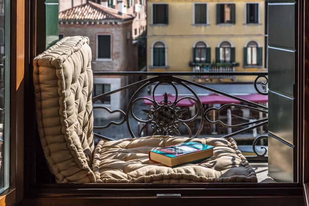 Typical Venetian balcony with a book and view on the campo - Rental Apartment in Venice